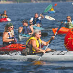 CONGESTION ON THE POND â€” Deb Collier of Bridgton, a member of the Life is Good team, leads a group of paddlers around a turn marker during Saturdayâ€™s Great Adventure Challenge. (Rivet Photo)