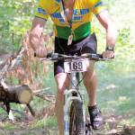 NEW & IMPROVED GIMP â€” Walt Grzyb, a member of the New & Improved Gimps team, tackles the bike course. (Photo by Greg Van Vliet/Lake Region Photography.com)