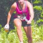 TOUGH CLIMB â€” Emily Hursty steps up onto a rock along the trail leading to Pleasant Mountainâ€™s summit. (Rivet Photo)