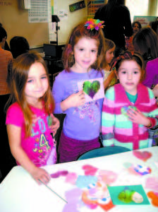 SONGO LOCKS SWEETHEARTS: From left to right, Jennessa Gaston, Ella Martin, and Haily were among the children who made and sold Valentines hearts for 10 cents each to raise $296 for Harvest Hills Animal Shelter. While doing the community service project, the kindergarten students â€” who attend Songo Locks Elementary School â€” engaged in arithmetic and writing plus got a daily dose of arts and crafts. (De Busk Photo)