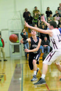 JONATHAN BURK barely manages to zip a pass along the baseline just beyond the reach of a Greely player. (Rivet Photo)
