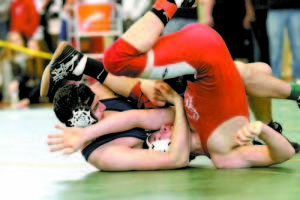 A WINDJAMMER IN A JAM â€” Fryeburg Academy's Ian MacFawn takes down a Camden Hills wrestler during Saturday's Class B State Championship Meet at Wadsworth Arena. MacFawn won the state title at 182 pounds.