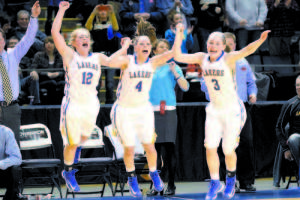 COUNTING DOWN THE FINAL SECONDS â€” As the final seconds ticked off the Cumberland County Civic Center scoreboard, the Hancock trio â€” Sarah (12), Sydney (4) and CeCe (3) â€” celebrate Lake Region's West championship victory over York. The Lakers (19-2) advance to Friday's state championship game against Presque Isle (21-0) at the CCC at 7 p.m. (Rivet Photo)