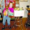 ALLISON BAKER, A BROWNIE SCOUT with Troop 1963, poses with one of the boxes of non-perishable items she collected during a food drive she organized for the Naples Food Pantry. (De Busk Photo) 