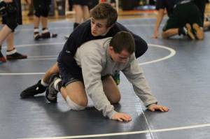 FAMILY AFFAIR â€” Connor and brother, Zach (bottom), go through a warm up prior to the Class B state finals at the Academy. (Rivet Photo)