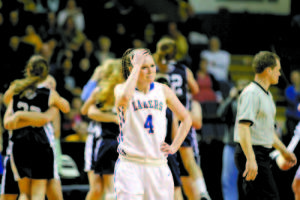 DEJECTED â€” Lake Region senior Sydney Hancock reacts as Presque Isle players celebrate winning the state finals last Friday at the Cumberland County Civic Center. (Rivet Photos)