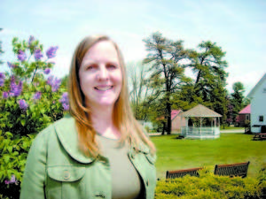 Naples Town Secretary Harriet Condon stands in front of the Village Green on Monday afternoon. Condon was hired last month as town secretary. Previously, she worked for the Town of Southington, Conn., for 15 years. (De Busk Photo)  