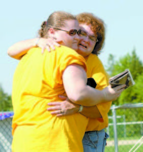 TOUCHING TIME â€” Lyn Carter (right) hugs daughter, Jan, during the dedication of the Laurie Carter-Bergen Memorial Field. Laurie, Jan's twin, died a short time after giving birth to her daughter.