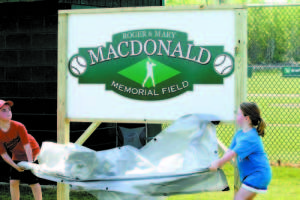 UNVEILED â€” Kyan (left) and Quinn Macdonald unveil the field sign at the Roger and Mary Macdonald Memorial Field.