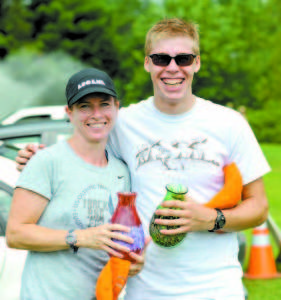 REPEAT WINNERS Terry Ballou and Silas Eastman hold their Lovell Old Home Days 5K glass-blown trophies. (Photo courtesy of Frederic Sater)