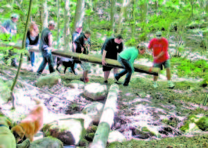 TRANSPORTING BRIDGE MATERIALS â€” Crooked River Academy students carry one of the stringers for a new bridge on the Douglas Mountain Scout Trail.  Pictured left to right are Justin Rice, Taylor Garrett, Mark Kemp-Libby, Cody Parker, Derek Secord, Dakoda Bellavance and instructor Brian Clark. (Photos by Allen Crabtree)