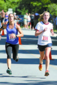 DRAMA DOWN THE STRETCH â€” Emma Decamp (right), 18. of Washington, D.C. fought off a challenge down the stretch from Jaclyn Pavlos, 25, of Poland to claim the women's title at the Casco Days Four Miler.