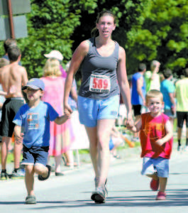 JANE CHAPPELL of Naples walks to the finish line accompanied by two future Casco Days participants?