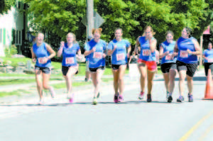 UNITED IN THEIR APPROACH TO THE FINISH LINE â€” Runners from Camp Arcadia stretched a line across Main Street in Casco Village as they finished the annual Casco Days four miler. Pictured left to right are: Fiona Sharp, Lucy Davis, Bella Miller, Annabel Barry, Veronica Rodriguez, Grace Hoffman and Heather Benninghoven.