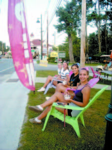 A business displays wares on the Causeway. Proposed amendments to a street vendor ordinance will require a permit only if someone subleases their property to a street vendor. Enjoying ice cream on the Causeway are (front to back) Frances Kimball, Emily Secord, Jacqueline Laurent and Mikayla Fortin. (De Busk Photo)
