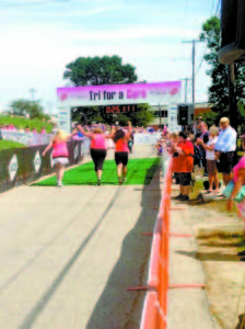 FINISHING TOGETHER â€” As Kelly Johnson approached the Tri for a Cure finish line, she was joined by her teammates, Joanne Jordan and Cynthia Bianco. Tri for a Cure 2013 Goal: $1 million Raised: $1,259,014 Top 3 Individuals: 1. Kendra Jarratt, 1:17:26.1 2. Renee Durgin, 1:19:34.2 3. Elizabeth Strawbridge, 1:19:59.0 Local finishers: 73. Kristin Fielding, 40, Raymond, 1:32.40.2 110. Carrie Boudreau, 46, Raymond, 1:35.42.9 117. Elizabeth Crockett, 29, Raymond, 1:36.11.8 124. Phoebe Crockett, 22, Raymond, 1:36.45.3 132. Maria McInnis, 34, Raymond, 1:37.13.6 158. Kristina Stevens, 45, Fryeburg, 1:39.10.4 182. Crystal Drew, 34, Center Lovell, 1:40.34.0 185. Linda Christensen, 49, Sebago, 1:40.35.9 287. Erin Plummer, 30, Naples, 1:435.38.2 341. Susan Crockett, 54, Raymond, 1:49.38.3 425. Amy Pond, 38, Naples, 1:56.24.6 485. Ellen Gagne, 46, Raymond, 2:02.52.3 489. Kim Hutchins, 53, Sebago, 2:03.35.7 529. Janet Harris, 34, Raymond, 2:11.00.7 547. Rebecca Vose, 47, Naples, 2:15.44.6 563. Kathleen Roche-Tolman, 50, Raymond, 2:22.28.5 568. Ansley Hansen, 25, Sebago, 2:23.41.8 585. Lynn Harrison, 69, Bridgton, 2:38.39.4 