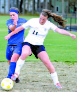 BATTLING FOR POSSESSION are Izzy Hodgman-Burns of Fryeburg Academy (right) and Bailey Crawford of Lake Region (left).