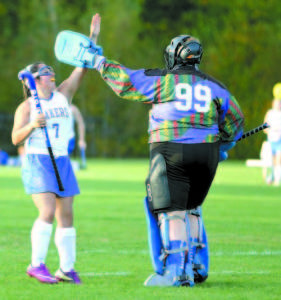 NICE GAME — Lake Region junior Bridgette Letarte congratulates goalie Meghan VanLoan following last Thursday's win over Fryeburg Academy.