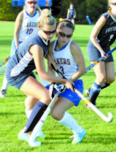 ENTANGLED — Finding themselves up close and personal trying to gain possession of the ball are Madison Davis of Fryeburg Academy and Lake Region's Courtney Yates.