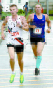 CHASE IS ON â€” Silas Eastman of Chatham, N.H. and former Fryeburg Academy standout runner (right), looks to pass Robert Hall of Windham as they head down the home stretch.