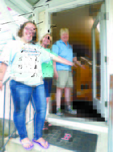 VILLAGE STORE OPENS DOORS — (From left to right) Jennifer Morgan, Kay Mahoney and owner Evelyn Meserve gesture to the open door of Casco Village Variety, which had a soft opening over the weekend. The remodeled store is located off Route 121 in the building of the former AG Store. (De Busk Photo)