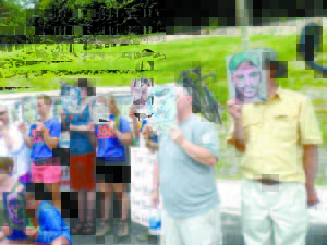 People hailing from Vermont, New Hampshire, Maine and Massachusetts hold sketches of the faces of the 47 people who died last July after a rail car containing heavy crude exploded in Lac-MÃ©gantic. The peaceful protest for clean energy was held in Bretton Woods, N.H., on Sunday. (De Busk Photo) NW dd29 Photo memorial for victims in LM This bus, which runs on a vegetable-based gasoline, served a memorial for the 47 people who died in Lac-MÃ©gantic on July 6, 2013. (De Busk Photo)    