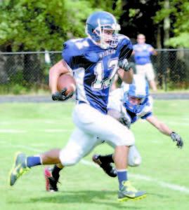 HE WOULDN'T BE DENIED â€” After catching a quick pass, Raider senior receiver Ben Southwick raced past two Kennebunk defenders to score the game's winning touchdown Saturday. Fryeburg rallied from a 12-0 deficit in the fourth quarter to beat the Rams. (Rivet Photos)