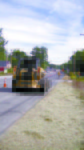 EARLIER THIS WEEK, a crew from Glidden Excavating and Paving prepares for the paving job that will take place Wednesday and possibly today. One-lane closures will occur on that stretch of Route 302 near the Route 11 junction, as a turning lane is being installed to facilitate traffic traveling to Dunkinâ€™ Donuts. (De Busk Photo)