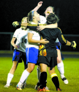 CELEBRATING A BIG HOMECOMING WIN â€” There were plenty of hugs being shared after the Lakers edged Traip Academy 2-1 last Wednesday night. Pictured (left to right) are Danica Chadwick (#14), Devynn Turner, goalie Isabel Scribner (back to) and Grace Farrington. (Rivet Photo)