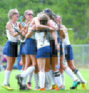 EARLY CELEBRATION â€” Teammates congratulate Nicole Thurston after scoring on a penalty stroke late in Saturday's prelim tournament game against Greely. (Rivet Photo)