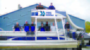 THE CREW FROM Long Lake Marina poses aboard “the fun boat.†Long Lake Marina recently acquired property in Bridgton with ample boat storage space, a maintenance shop plus a show room. Last fall, when the marina’s Naples-based boat storage facility reached its capacity, owner Jim Davenport knew it was time to expand the business again. (De Busk Photo)