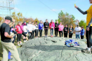 TIME FOR REFLECTION â€” When the group reached the summit, they had a moment of silence in honor of those lost. (Photo by Nicole Fox)