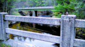 VEHICLES CROSS the Crooked River Bridge while traveling along Route 302 as seen from the old bridge. The status of the old bridge has been brought up at recent Casco Board of Selectmen meetings, but since no money has been allocated for this project, itâ€™s unlikely the aging concrete bridge will be removed any time soon. (De Busk Photo) 