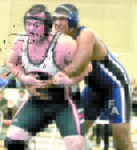 ANGEL ESCALANTE of Fryeburg Academy (right) found himself in a tough heavyweight match against a Lisbon wrestler during Saturday's opening season meet held at Wadsworth Arena. Escalante lost this match in sudden death. (Rivet Photo)
