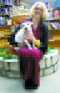 DURING HER FAREWELL PARTY on Sunday, Casco Public Library Director Carolyn Paradise poses with her dog Millie. Paradise is resigning from her position at the library and moving to Rhode Island to help her working daughter and son-in-law with their infant, Paradiseâ€™s new grandson. (De Busk Photo)