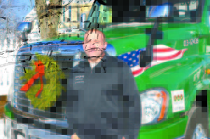 POLAND SPRING TANKER DRIVER SCOTT EDWARDS is pictured with the Poland Spring tractor-trailer he will drive in the Wreaths Across America caravan. 