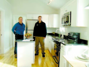 SPACIOUS FOR THE SIZE â€” Cathedral ceilings give a sense of spaciousness to the full-size kitchen inside the cottage.  