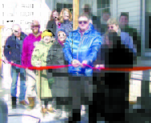 POSING FOR FEB. 11 RIBBON-CUTTING ceremony are: (Front row, left to right) Lake Region Green Independent Party member Joe Cerny, of Gorham; Lake Region Green Independent Party member Mike Wakefield, of Standish; Casco Energy Committee member Nadia Hermos; Loon Echo Land Trust board member Connie Cross; Casco Town Manager Dave Morton; and Casco Energy Committee Chairman Peg Dilley; (Middle, behind Dilley) Hybrid car owner Carl Bishop, Howell Laboratories employee; (Back row, left to right) Attorney Dawn Dyer; Sebago Lakes Region Chamber of Commerce Director Amee Senatore; Casco Selectman Mary-Vienessa Fernandes; Lake Region Green Independent party member Lisa Willey, of Casco; and Chairman of Casco Board of Selectmen Grant Plummer. (De Busk Photo)