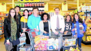 HELPING WITH HUNGER â€” Fryeburg Academy International students and Hannaford in Bridgton help to feed area school children. From left to right are Xinyu â€™Sindyâ€™ Du, Yiren â€˜Ethanâ€™ Wang, Gulsen Oztosun, Zheng â€˜Alexâ€™ Liu, Runairy Infante Store Manager Ken Hedley, Tshering Sherpa, and Xiyuan â€˜Adaâ€™ Huang. (Photo courtesy of Sharon Libby, Fryeburg Academy)  