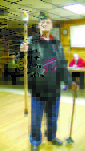 DELVIN MERRILL â€” a veteran and prisoner of war (POW) during the Korean War, holds up his eagle cane for people to see at the American Legion Post No. 155 meeting on Tuesday. (De Busk Photo) 