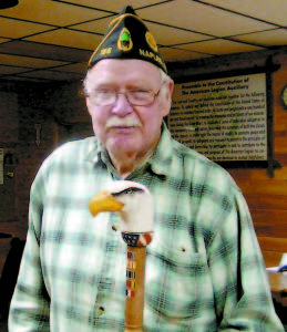 WORLD WAR II VETERAN â€” Fred Gilman receives a custom-carved eagle cane on Tuesday evening. (De Busk Photo) 