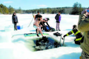 IN OVER HIS HEAD â€” Dylan DiMartino of Denmark got a shock from the icy waters of Moose Pond at last yearâ€™s Denmark Plunge, but itâ€™s all for a good cause â€” raising money for Heifer International's program to send poor girls from developing countries to school.