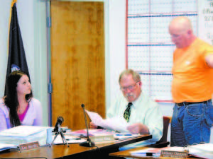 QUICK TO RESPOND â€” Resident Mark Lopez, right, was quick to rebut concerns raised at Tuesdayâ€™s Bridgton Selectmenâ€™s meeting that photocopied signatures on a citizensâ€™ petition concerning the Town Hall were not valid. Studying the signatures is Selectmen Chairman Bernie King, while Town Secretary Samantha Eichols looks on. Selectmen decided to allow the signatures, and sent the petition to be decided by voters in June. The petition would freeze all spending on Town Hall repairs until the total costs are known, then require voter approval of those costs. (Geraghty Photo)  Voters face lengthy referendum ballot June 9 By Gail Geraghty Staff Writer Bridgton Selectmen have finalized a comparatively lengthy list of referendum questions that voters will decide by secret ballot on Tuesday, June 9, the day before the Town Meeting. Several are the result of a citizensâ€™ petition, and others are ordinance revisions by the Planning Board. What follows are summaries of each question, along with comments made at Tuesdayâ€™s Selectmenâ€™s meeting.  Via Citizen Petition â€¢ Town Hall Spending â€” Approval of this question seeking cost estimates on both the exterior and interior of the Town Hall would freeze spending until total costs are known and approved by voters (See story, page 1)  â€¢ Lake Region Bus Service â€” Submitted last December, this petition would bring the Regional Transportation Programâ€™s bus service to Bridgton by approving a one-cent increase on the mil rate, estimated to be around $10,000.  â€¢ Sewer Ordinance â€” Approval would exempt all sewer allocations bought before July 1, 2014 from any and all amendments to the Sewer Ordinance, and would allow the exempted users to pay for only the portion of their total allocation that they use. Selectmen believe passage would stymie development in the downtown by preventing the town from buying back unused allocations in order to add more users to the system. The petition was brought forward by Tom Kennedy and others who are challenging changes to the sewer ordinance.  Via Planning Board â€¢ Tower Ordinance â€” Approval would further define and clarify requirements that telecommunication towers must meet, such as distance from abutters.  â€¢ Site Plan Review Ordinance â€” Approval would add a section regulating the location and operation of Medical Marijuana Dispensaries. â€¢ Sign Ordinance â€” Approval would further define requirements for flashing signs, among other housekeeping changes.  â€¢ Shoreland Zoning Ordinance â€” Approval of revisions that ensure compliance with state requirements and other housekeeping changes.  â€¢ Establishment of Safe Zones Ordinance â€” Approval would give additional definition to existing ordinance and compliance with language on Medical Marijuana Dispensaries.  Not all proposed referendum questions were approved for the June 9 ballot. Selectmen decided not to send along a proposal to make Home Run Road a town road, because as yet the Memorandum of Understanding has not been signed with the Home Run Road Abutters Group. The BRAG athletic field lies at the end of the road, which connects with Sandy Creek Road.  The board also decided not to seek referendum approval to add $9,000 to the budget for the Bridgton Library, as was suggested at the last meeting by Selectman Bob McHatton. Instead, the $9,000 will be added to the Bridgton Library budget as a line item in the budget that voters will decide at the Town Meeting on Wednesday, June 10.  