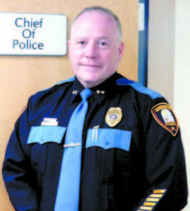 FOR NOT MUCH LONGER â€” Bridgton Police Chief Kevin Schofield stands beside the door to his office, which heâ€™ll be leaving on April 10 after four years to become police chief in Windham.    