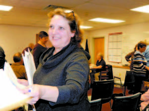 TIRELESS HELPER â€” Anne Krieg, Bridgtonâ€™s Director of Planning, Dconomic and Community Development, passed out copies of Casco Bay Engineeringâ€™s proposal to inspect the interior of Town Hall, which has not yet been done. Selectmen agreed to have the firm do the interior analysis, and also voted to put the exterior Phase I work out to bid. (Geraghty Photo)  