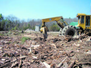 HEAVY MACHINERY stands still after Chaplin Logging cleared the lot, which was purchased by the Town of Naples last autumn. The lot may be used for storing vehicles and parking. However, there are no construction projects on the horizon, according to Town Manager Emphrem Paraschak. (De Busk Photo)