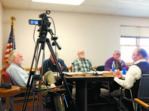 ASSESSING THE ASSESSOR â€” Bridgton Town Manager Bob Peabody, left, listened Tuesday as Michael Oâ€™Donnell of John E. Oâ€™Donnell & Associates, right, explained his companyâ€™s revaluation process. Also listening were Selectmen Bob McHatton, Paul Hoyt and Doug Taft.   (Geraghty Photo)