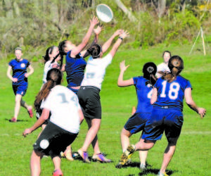 FIGHT FOR THE DISC â€” In action against Amherst JVA, Raider Ultimate player Esmeralda Hernandez battles for possession. FA players pictured include Thu Pham (#2), Sydney Andreoli (#18) and Erin Friberg (in the background). (Photo by Joseph Kelly)      