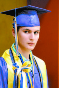 Class Marshall Michael Rust peers inside the Lake Region High School gymnasium before the start of last Sunday's graduation ceremony. (Rivet Photo)