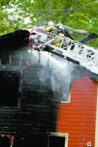 FIREFIGHTERS from Bridgton, Harrison, Naples and Fryeburg battled the early morning blaze. (Rivet Photo)